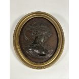 A 19th century bronze bas relief oval panel, probably French, depicting a profile bust of a lady