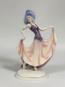 Katzhutte, a large Art Deco porcelain figure of a lady in a picture hat, holding the hem of her