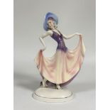 Katzhutte, a large Art Deco porcelain figure of a lady in a picture hat, holding the hem of her