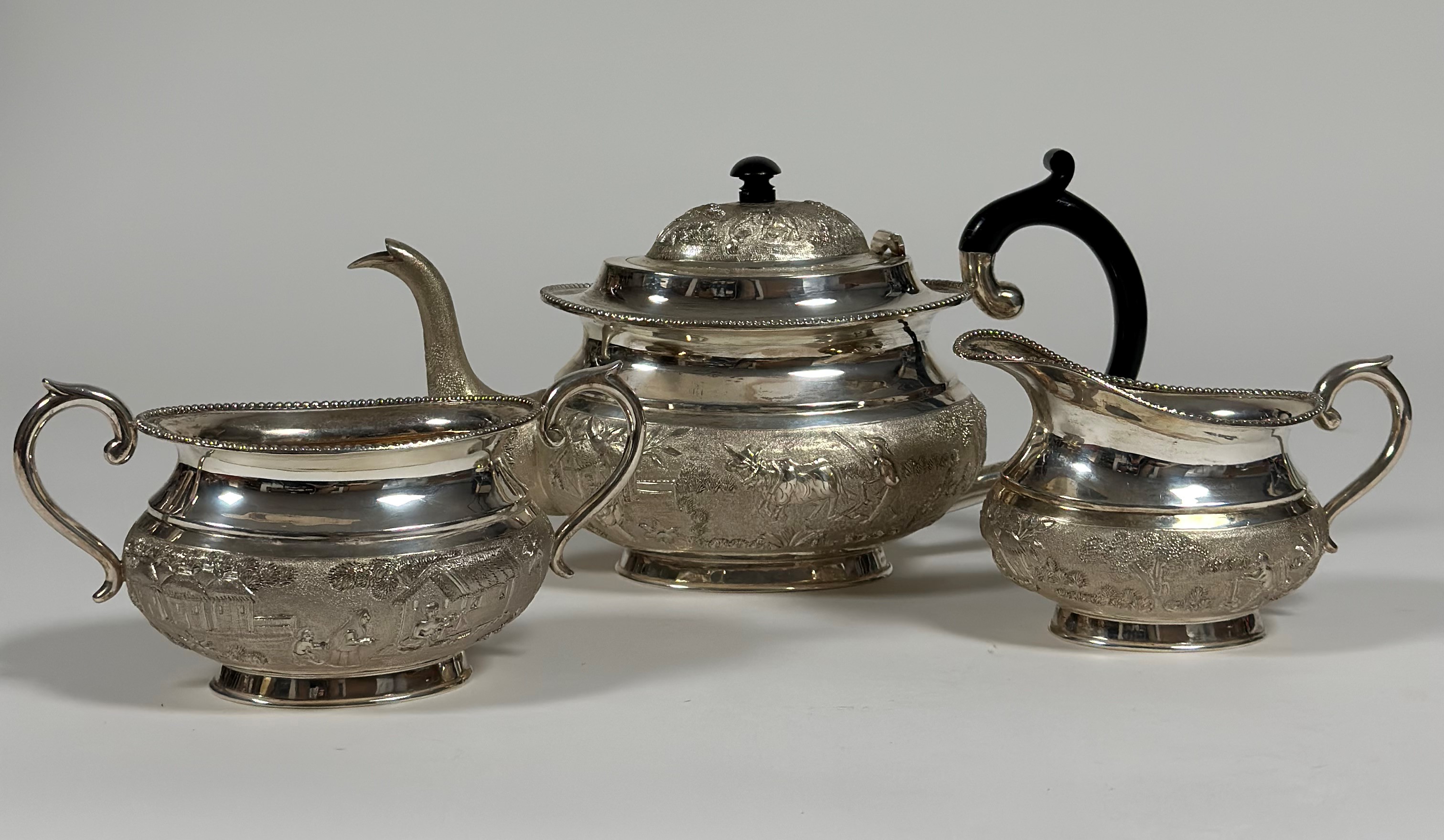 A South-East Asian sterling silver three piece tea service, mid-20th century, each piece of oval