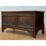 A 17th/early 18th century oak coffer, the panelled top opening to a plain interior, over twin