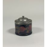 A William Moorcroft Pomegranate pattern pewter-mounted biscuit barrel, the planished domed cover