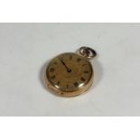 A 14ct gold lady's open face fob watch, c. 1900, the gilt dial with Roman numerals, keyless wind