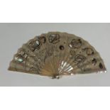 A French mother of pearl and sequin fan, c. 1900, the monture of white mother of pearl with bone