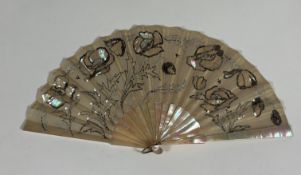 A French mother of pearl and sequin fan, c. 1900, the monture of white mother of pearl with bone