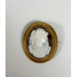 A 19th century yellow metal mounted shell cameo brooch, the oval cameo depicting a lady in 16th