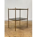 A mid-20th century two tier leather-inset brass occasional table, the cylindrical legs with acorn