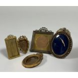 A group of small Edwardian gilt-metal photograph frames comprising: a square frame with ribbon-