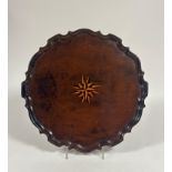 A George III satinwood inlaid mahogany tray, circular, with "piecrust" rim and central inlaid