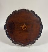 A George III satinwood inlaid mahogany tray, circular, with "piecrust" rim and central inlaid