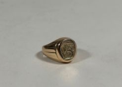 A 14ct gold signet ring, the oval plaque engraved with a crest on a tapering band. Ring size M (