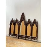 A mahogany framed Gothic Revival overmantel mirror of arcaded sectional form, late 20th century each