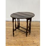 A late 18th century oak gateleg table, the oval hinged top over tapering columnar legs with blocks