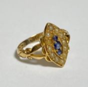 A late Victorian three stone sapphire and seed pearl ring, the three round-cut graduated sapphires