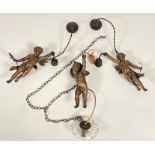 A set of three patinated metal figural hanging lights, early 20th century, each modelled as a