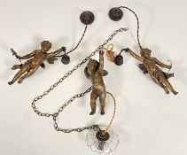 A set of three patinated metal figural hanging lights, early 20th century, each modelled as a