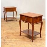 A pair of French cherry serpentine bedside tables, second half of the 20th century, each fitted with