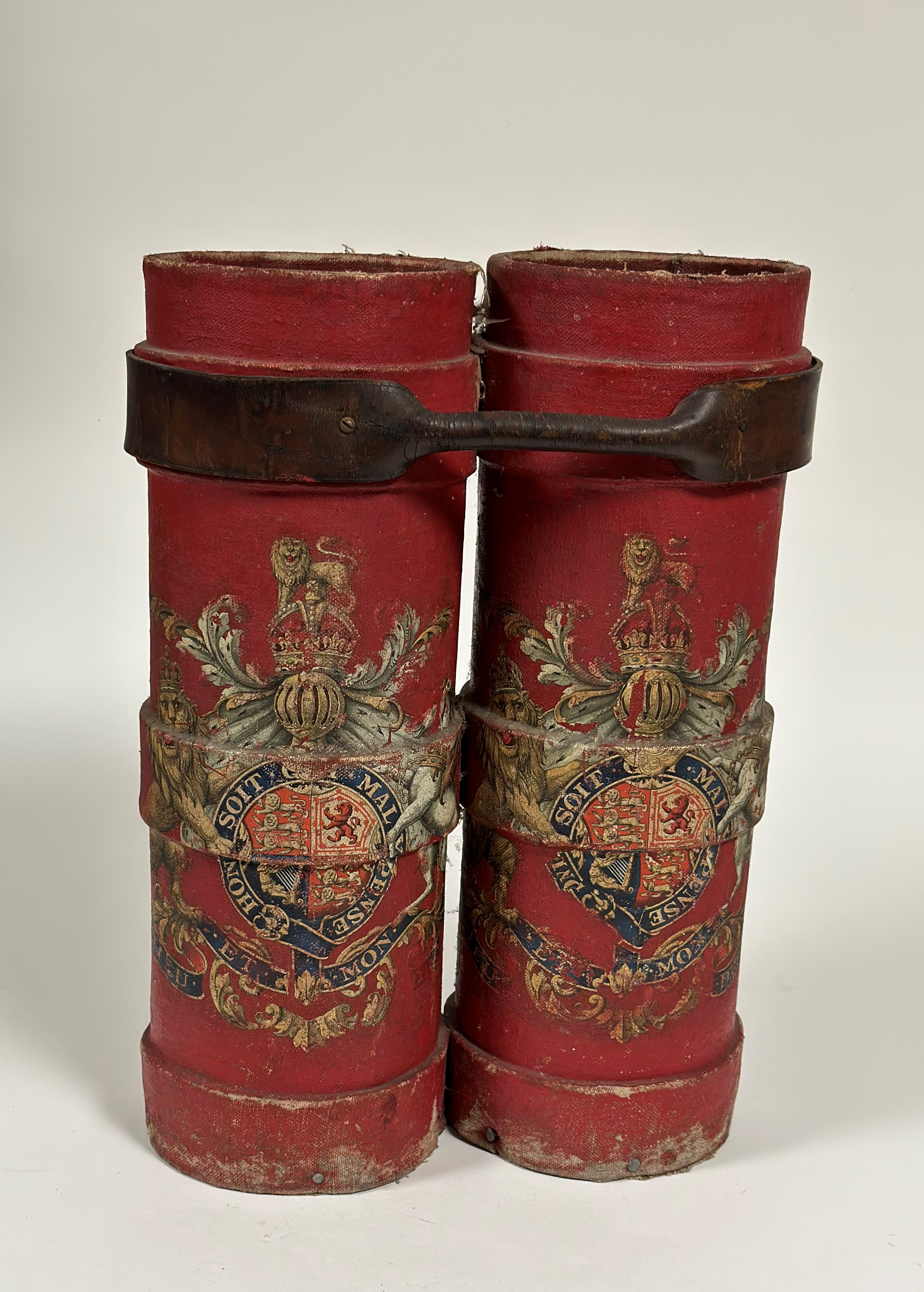 A pair of red canvas shell carrying cases, each emblazoned with the Royal Coat of Arms, bound