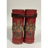 A pair of red canvas shell carrying cases, each emblazoned with the Royal Coat of Arms, bound