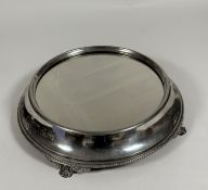 A silver-plated circular surtout de table, c. 1900, Walker & Hall, Sheffield, the mirrored plateau