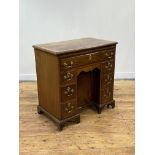 A George III mahogany knee-hole desk, circa 1760, the top with ebony string inlay and a deep cross