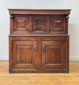 An 18th century oak court cupboard of pegged contruction, the projecting top over channel moulded
