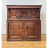 An 18th century oak court cupboard of pegged contruction, the projecting top over channel moulded