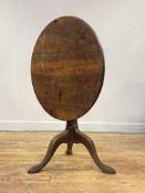 A Georgian mahogany tilt top table, mid 18th century, the circular top tilting on a bird cage, above