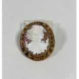 A large 19th century shell cameo brooch, oval, carved with a Bacchanalian female bust, her hair