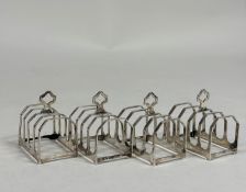 A set of four George V silver toast racks, Sir John Bennett Ltd., London, 1933, of four faceted