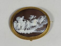 A 19th century shell cameo brooch, the oval plaque carved to depict Aurora being drawn in her