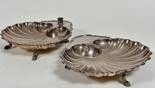 A pair of Epns shell shaped dishes, one with candle holder to top, of scalloped form,