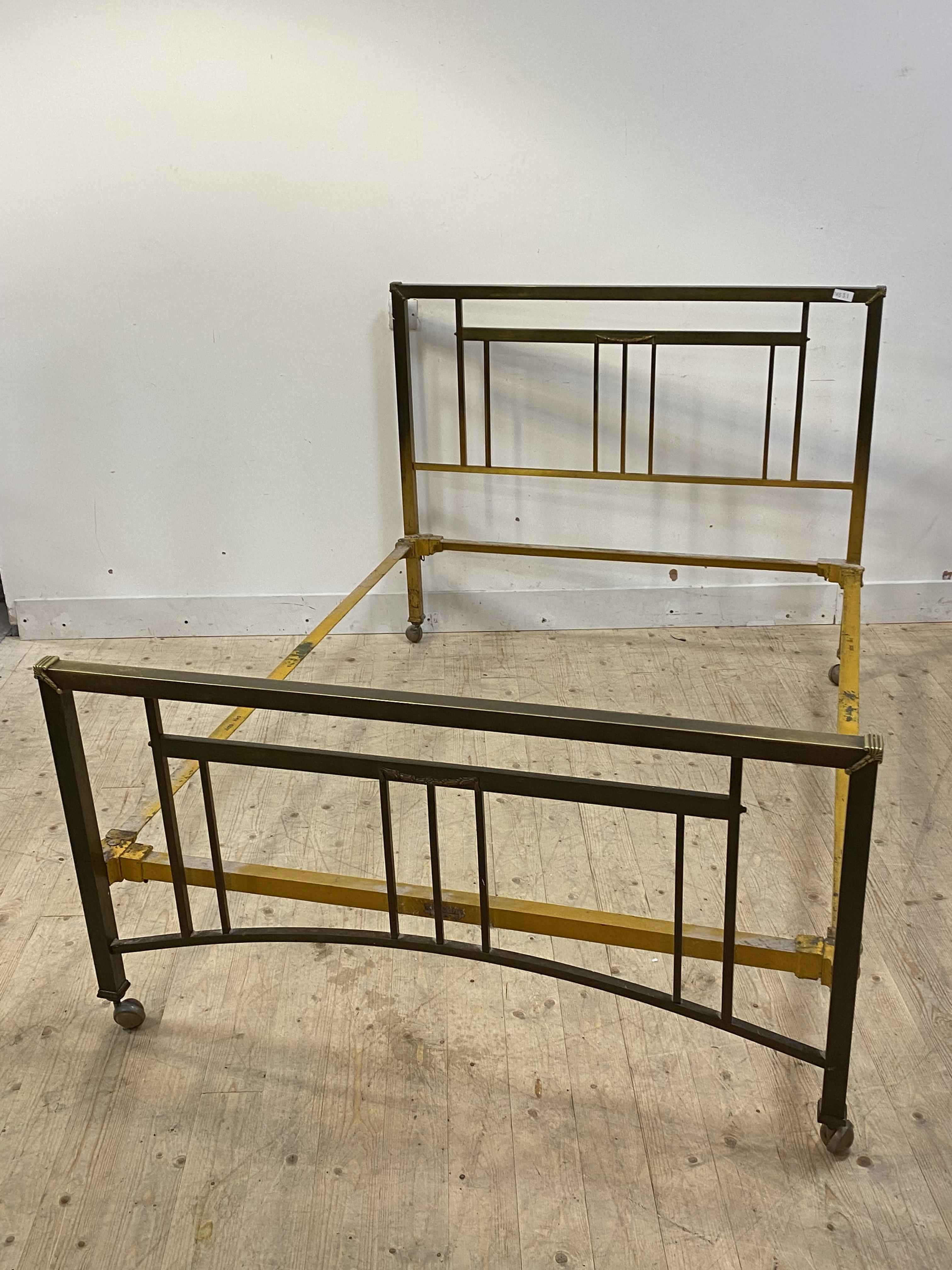 An early to mid 20th century square section brass framed 4'6" double bed, the frame with applied