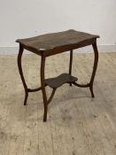 An Edwardian oak centre table of serpentine outline, raised on splayed supports united by an under