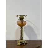 A late Victorian floral and spiral cast brass oil lamp with moulded cranberry glass reservoir,