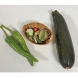 A miniature basket with lettuce, leeks, head of cauliflower, parsnips, two large green chili peppers