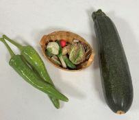 A miniature basket with lettuce, leeks, head of cauliflower, parsnips, two large green chili peppers