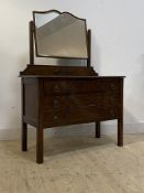 An early 20th centruy oak dressing chest, with swing mirror over three long drawers, on square