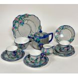 A fourteen piece 1920s tea set with handpainted floral scrolling leaf design with blue reserves