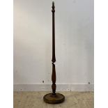 A turned mahogany standard lamp of Georgian design, with fluted column and moulded circular base,