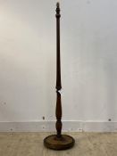 A turned mahogany standard lamp of Georgian design, with fluted column and moulded circular base,