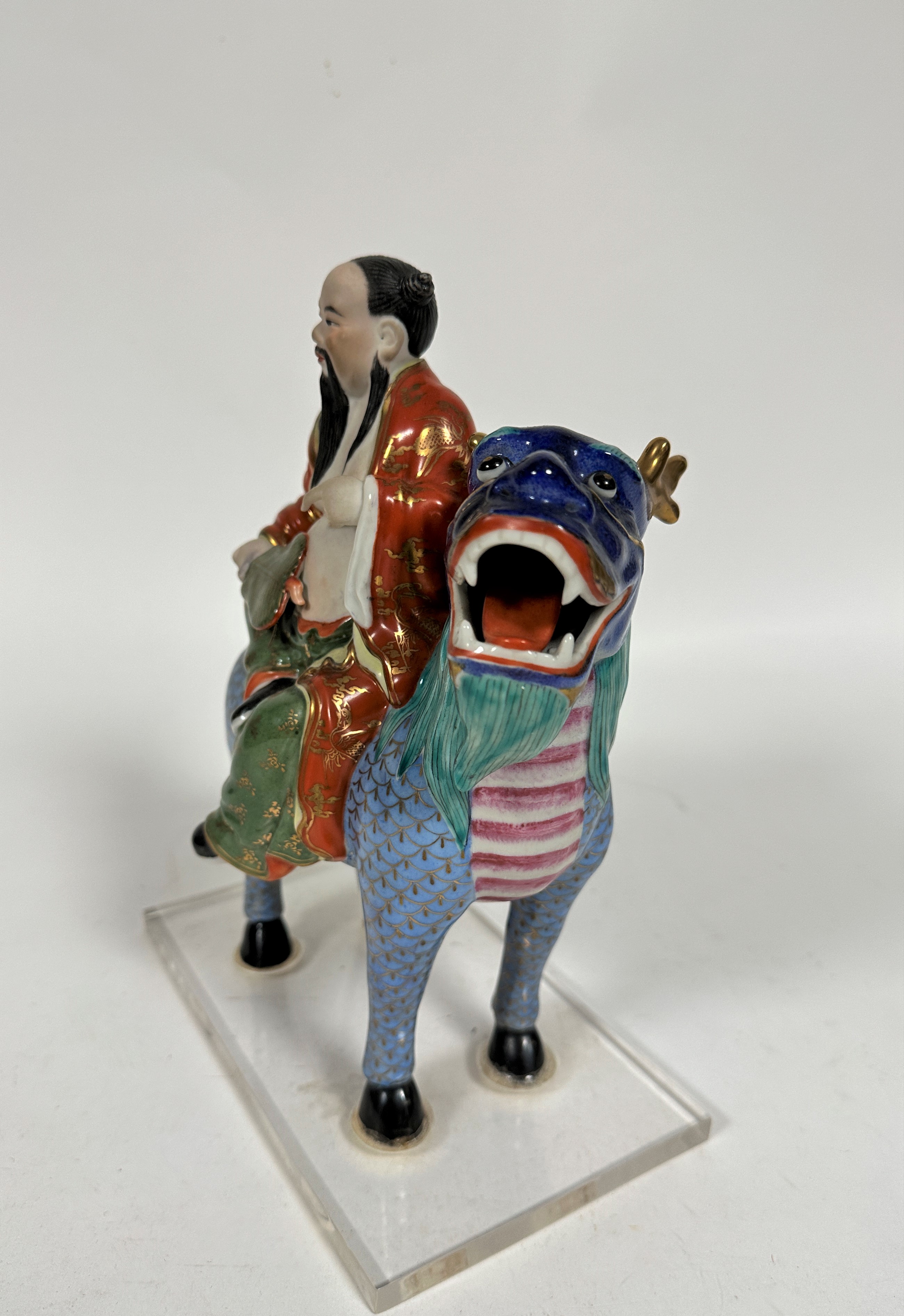 A Japanese porcelain Buddhist figure riding on a mythical stag, decorated with polychrome enamels, - Image 3 of 3