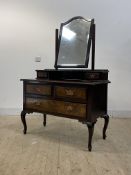 A late Victorian figured walnut dressing table, the swing mirror over two trinket drawers, with