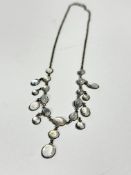 A white metal mounted moonstone set necklace of graduated oval drops, (L: 23cm)