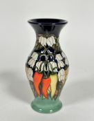 A Moorcroft baluster vase decorated with chili pepper and flower tube-lined design, with blue and