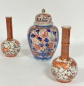 A Japanese baluster fluted vase and cover decorated with traditional Imari style design with blue