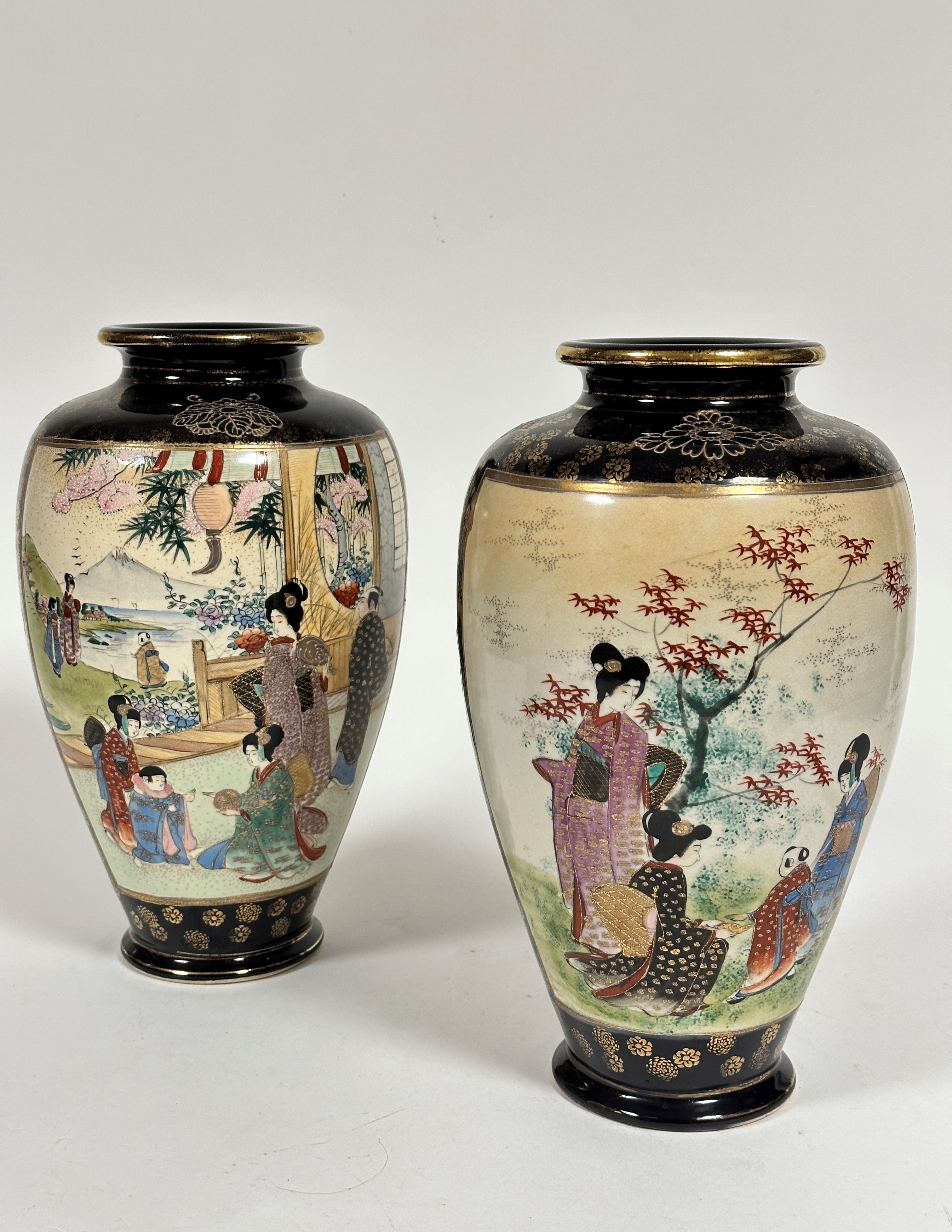 A pair of Japanese Satsuma ovoid tapered vases decorated with scenes in a garden of women playing