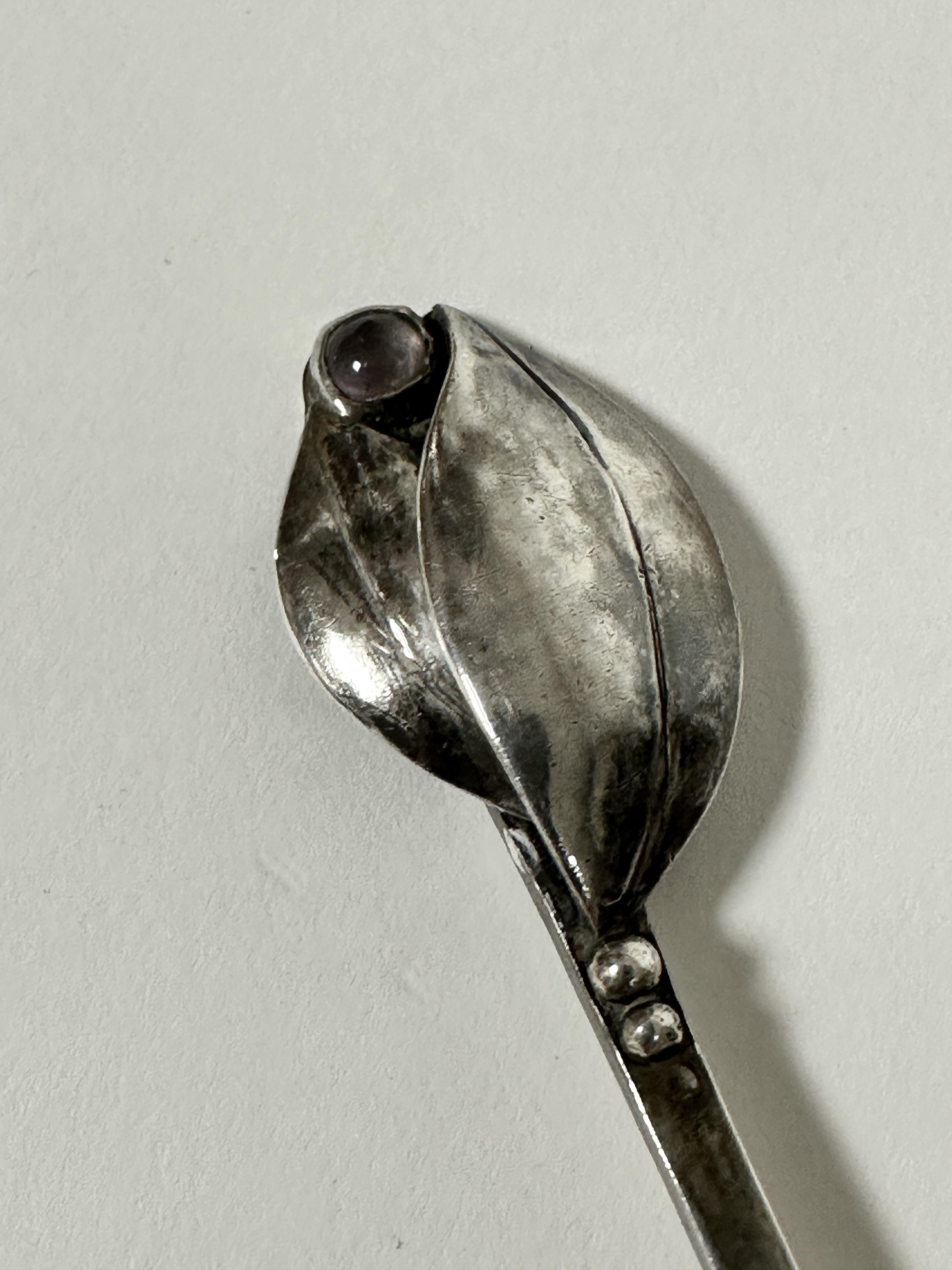 A Continental Georg Jensen style spoon, the square stem with twin leaf scrolling design inset with - Image 2 of 4