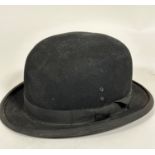 A 1920s / 30s gentleman's bowler hat, made of fine felt with satin lined interior, complete with
