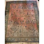 A large Persian carpet, hand knotted, the red field decorated with stylised trees and foliate